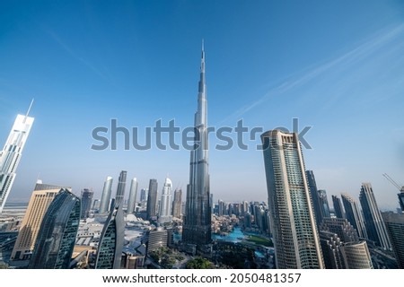 Blue sky image of Dubai mega tall skyscrapers. Ultra wide angle picture. 