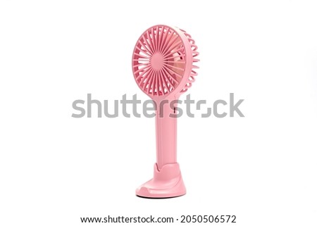 Closeup of a small pink fan isolated on white background.