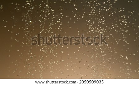 Close-up of champagne bubbles background. Texture of beverages background.