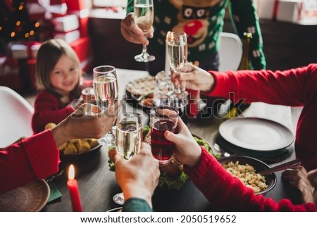 Photo of family friends small little childhood children parents noel sit big table clink glass toast x-mas indoors house