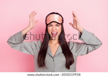 Portrait of attractive angry girl screaming bad mood insomnia late time isolated over pink pastel color background