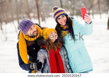 Photo of lovely family mom dad daughter happy positive smile make selfie cellphone vacation winter trip outdoors