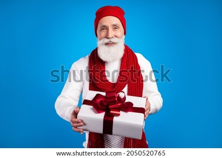 Photo of positive person hands hold giftbox toothy smile look camera isolated on blue color background