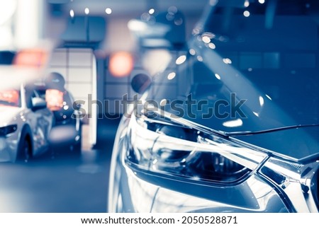 Selective focus grey car parked in luxury showroom. Car dealership office. New car parked in modern showroom. Car for sale and rent business concept. Automobile leasing and insurance background. Royalty-Free Stock Photo #2050528871