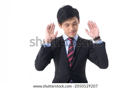 portrait of handsome young man model in suit ,tie with open hands posing in studio