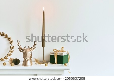 Christmas composition on the white chimney at the living room interior with beautiful decoration. Christmas tree and wreath, candles, stars, light. Copy space.  Template.