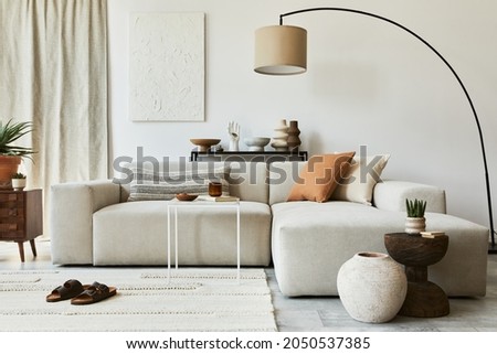 Creative composition of cozy living room interior design with mock up poster frame and structure painting, corner sofa, coffee table, textile and personal accessories. Scandinavian classic style. Royalty-Free Stock Photo #2050537385
