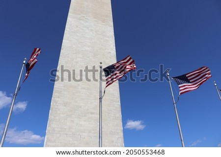 Washington Monument with USA flags in DC.