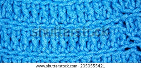 Pattern fabric made of wool. Handmade knitted fabric blue wool background texture