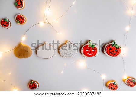 Step by step instructions on how to draw an orange pumpkin shaped gingerbread cookie using icing. DIY Master class from pastry chef in six steps. Halloween sweets on an isolated background. Copy space