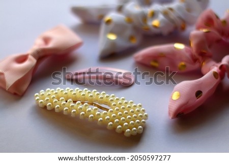 Various hair accessories in pastel and gold tones. Selective focus.