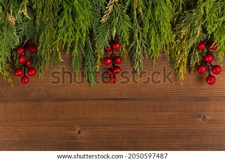 top view of christmas background decorated with branches of christmas tree and christmas decorations with free space for text.