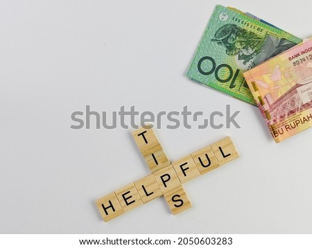 word conceptual of  helpful tips with money on white isolated background