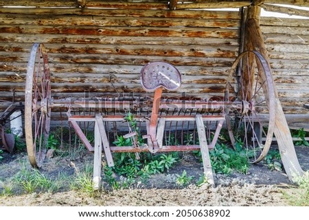 Horse rake in the courtyard of an old village house. Cossack estate in the village of Arkaim, Russia Royalty-Free Stock Photo #2050638902