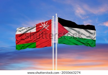  Oman and Palestine two flags on flagpoles and blue sky