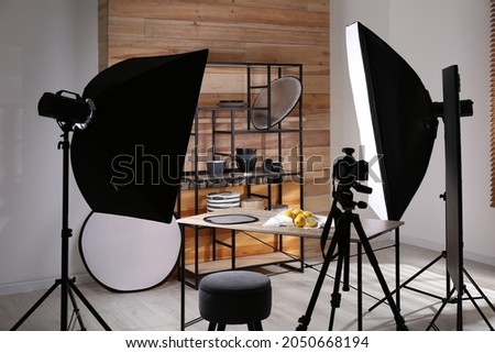 Professional equipment and many lemons on table in studio. Food photo