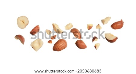 Pieces of tasty hazelnuts on white background Royalty-Free Stock Photo #2050680683