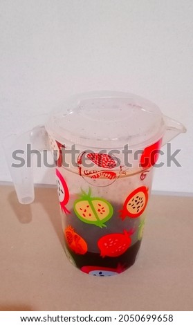 Half-filled coffee water in the kettle with fruit pictures