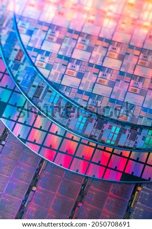 silicon chip wafer reflecting different colors Royalty-Free Stock Photo #2050708691