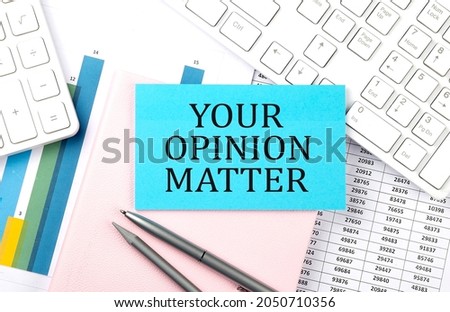 YOUR OPINION MATTER text on blue sticker on chart with calculator and keyboard,Business