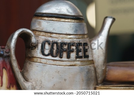 Photography of an old coffee pot. Word COFFEE. Gray color. Close up photography Royalty-Free Stock Photo #2050715021