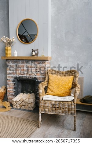 Grey living room and yellow room with fireplace and wooden decor. The style of the living room is Scandinavian.