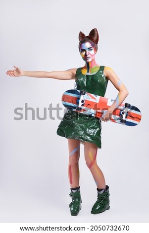 Model in creative comics character image with pop art makeup over gray background