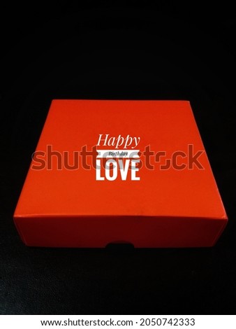 happy birthday love writing orange gift box with black background