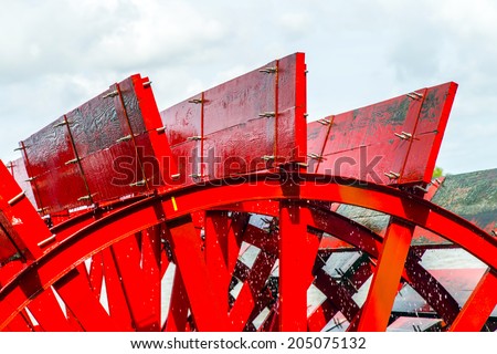 Red Riverboat Paddle Wheel in a River with Trees Royalty-Free Stock Photo #205075132