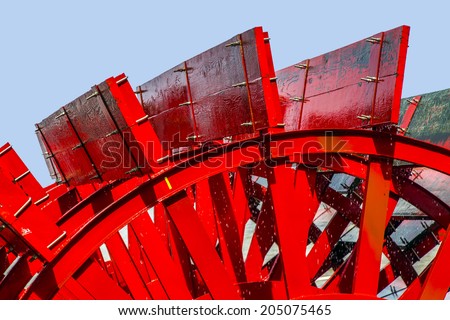 Red Riverboat Paddle Wheel in a River with Trees Royalty-Free Stock Photo #205075465