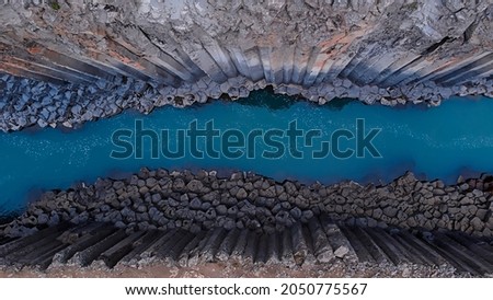 top down of studlagil canyon, extraordinary canyon with blue glacial river Royalty-Free Stock Photo #2050775567