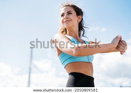 Coach, look at the smartwatch. The athlete leads a healthy lifestyle. Cardio training for weight loss. Sports and clothing for women. Fitness break in the city. Royalty-Free Stock Photo #2050809581