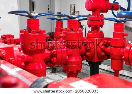 Petroleum oil and gas drilling equipment. Choke and kill manifolds are wellhead equipments that are assembled on the blowoul preventer units. Piping and valve system on offshore wellhead platform. Royalty-Free Stock Photo #2050820033