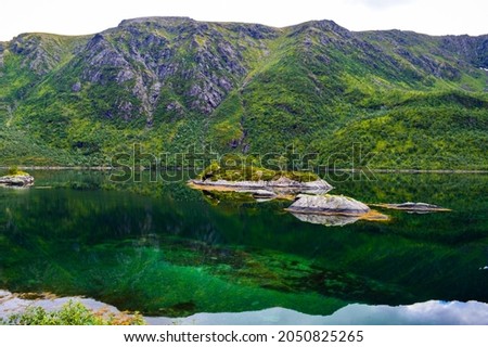 Mountain reflection in the water. Northern Norway nature. 