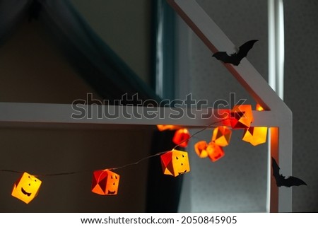 Handmade Halloween paper pumpkin garland and bat silhouettes. Holiday home decoration. High quality photo