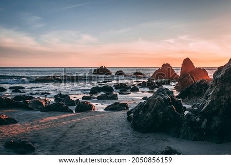 Rocky Beach Sunset with pink and vanilla clouds