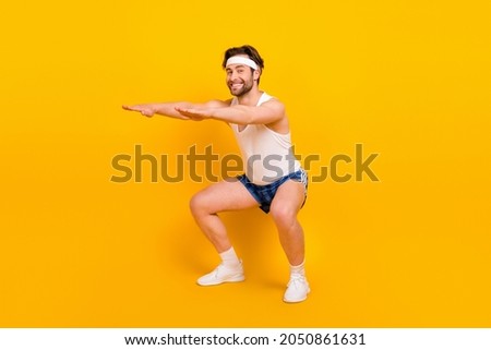 Full length body size view of attractive cheerful endurant guy doint sit-ups bodycare isolated over bright yellow color background