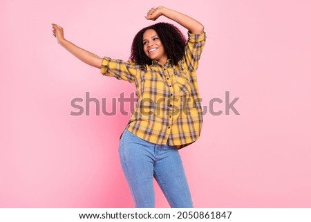 Photo of adorable shiny dark skin lady wear checkered shirt dancing smiling isolated pink color background