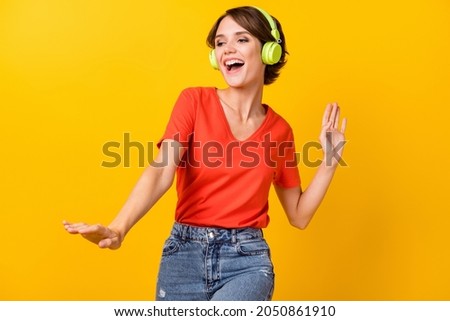Photo of nice brunette optimistic lady dance listen music wear red t-shirt isolated on vivid yellow color background