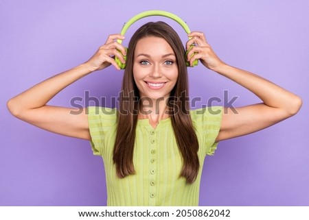 Photo of cheerful positive woman put head headphones music lover smile isolated on violet color background