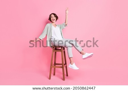 Full length photo of funny bob hairdo millennial lady sit dance wear grey green look isolated on pink background Royalty-Free Stock Photo #2050862447