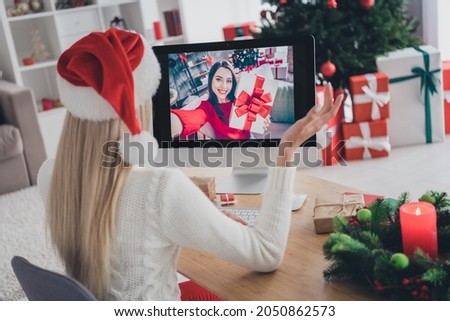 Back rear view photo of young girl speak talk video call computer congratulation new year season indoors Royalty-Free Stock Photo #2050862573