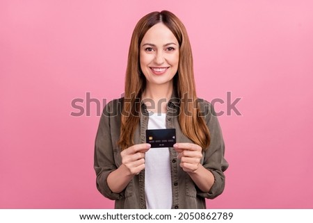 Photo of cheerful business woman present credit card promo choice money isolated over pink color background