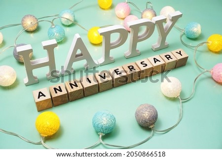 Happy Anniversary alphabet letter with LED cotton balls on green background Royalty-Free Stock Photo #2050866518