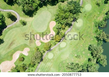 Aerial view drone shot of beautiful green golf field fairway and putting green Top down image for sport background and travel nature background Amazing view at Phuket Thailand.