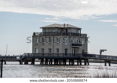 A large building built on stilts for hurricane flood protection