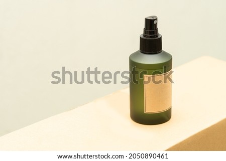 Green cosmetic bottle with label isolated on white background. Close up aroma spray bottle. Concept of organic cruelty free. Natural organic spa cosmetics concept.
