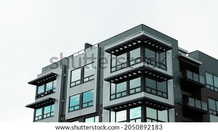 Apartments building against a cloudy sky Royalty-Free Stock Photo #2050892183