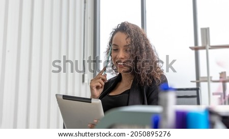 Young female office worker uses laptop for virtual meeting with customers or clients to enhance her business performance and service. Business woman uses technology for innovative business connection 