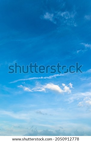 vertical Blue sky background with the sun,Blue sky with white clouds floating in the sky.